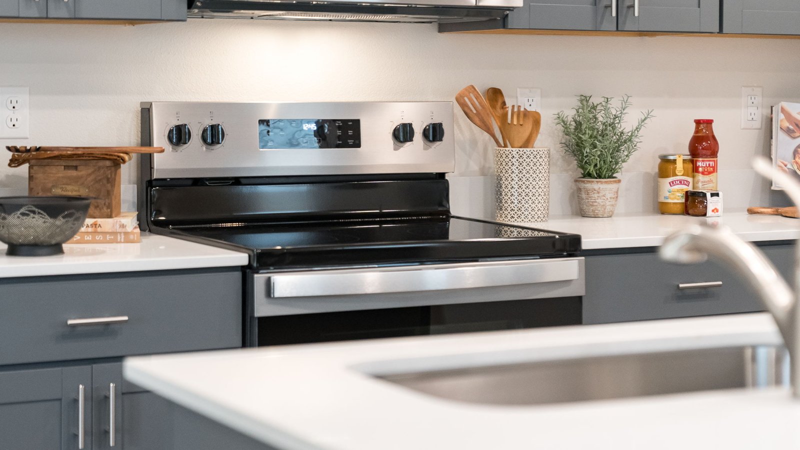 Kitchen with shaker cabinets, quartz counters, stainless steel appliances, pantry, and an island with a breakfast bar