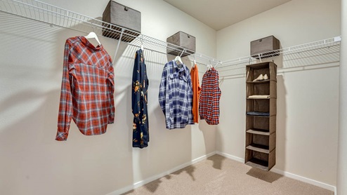 Primary bedroom walk-in closet with wire shelves