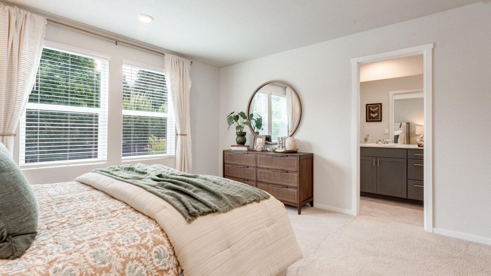 Primary bedroom with wall-to-wall carpet, a walk-in closet and an attached bathroom