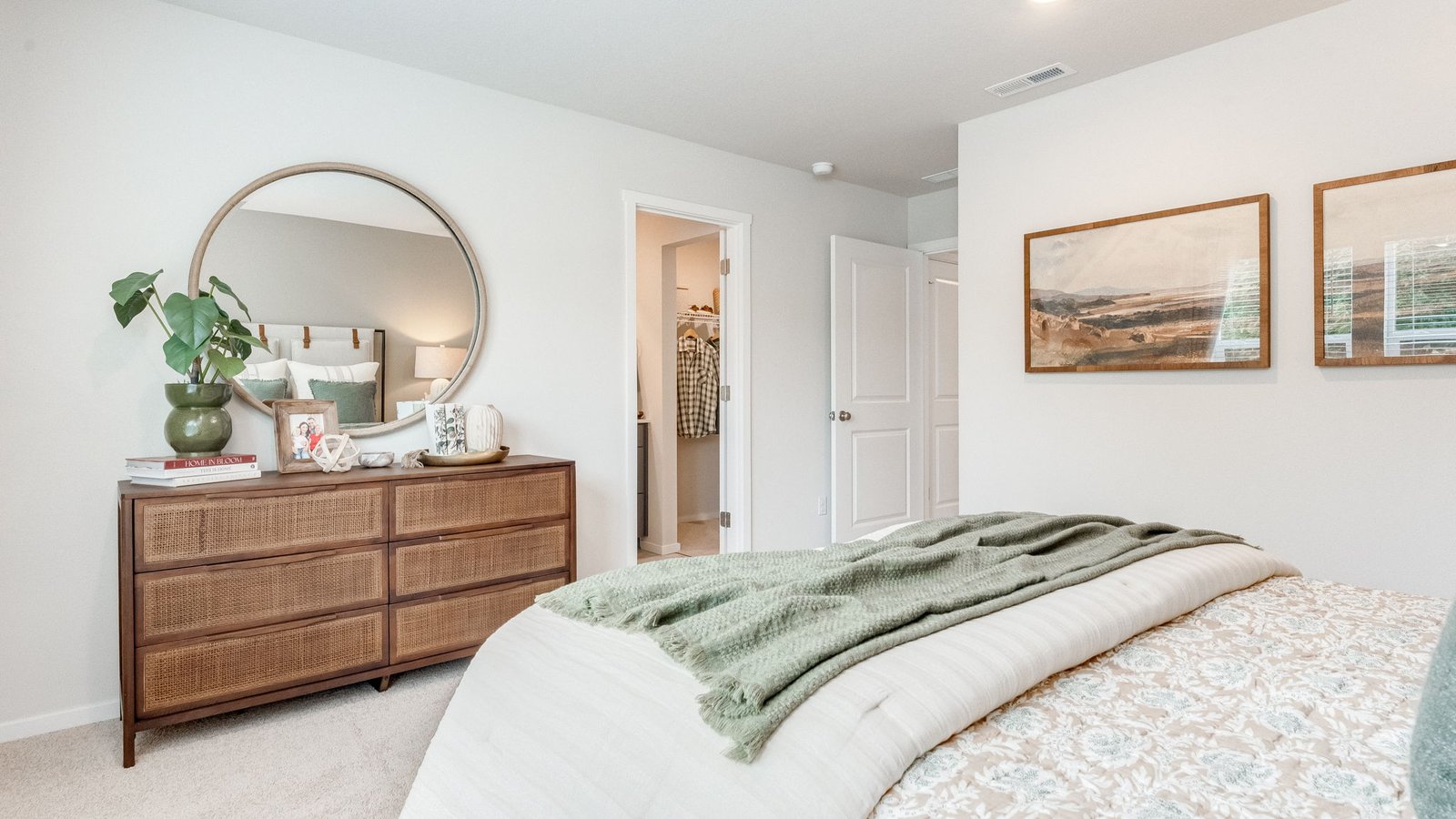 Primary bedroom with wall-to-wall carpet, a walk-in closet and an attached bathroom