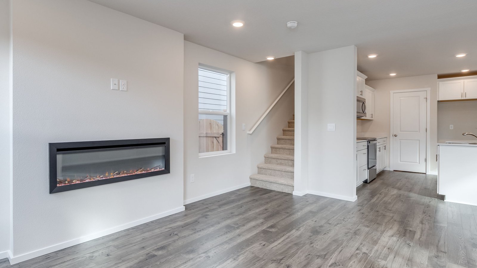 Great room with laminate flooring and an electric fireplace