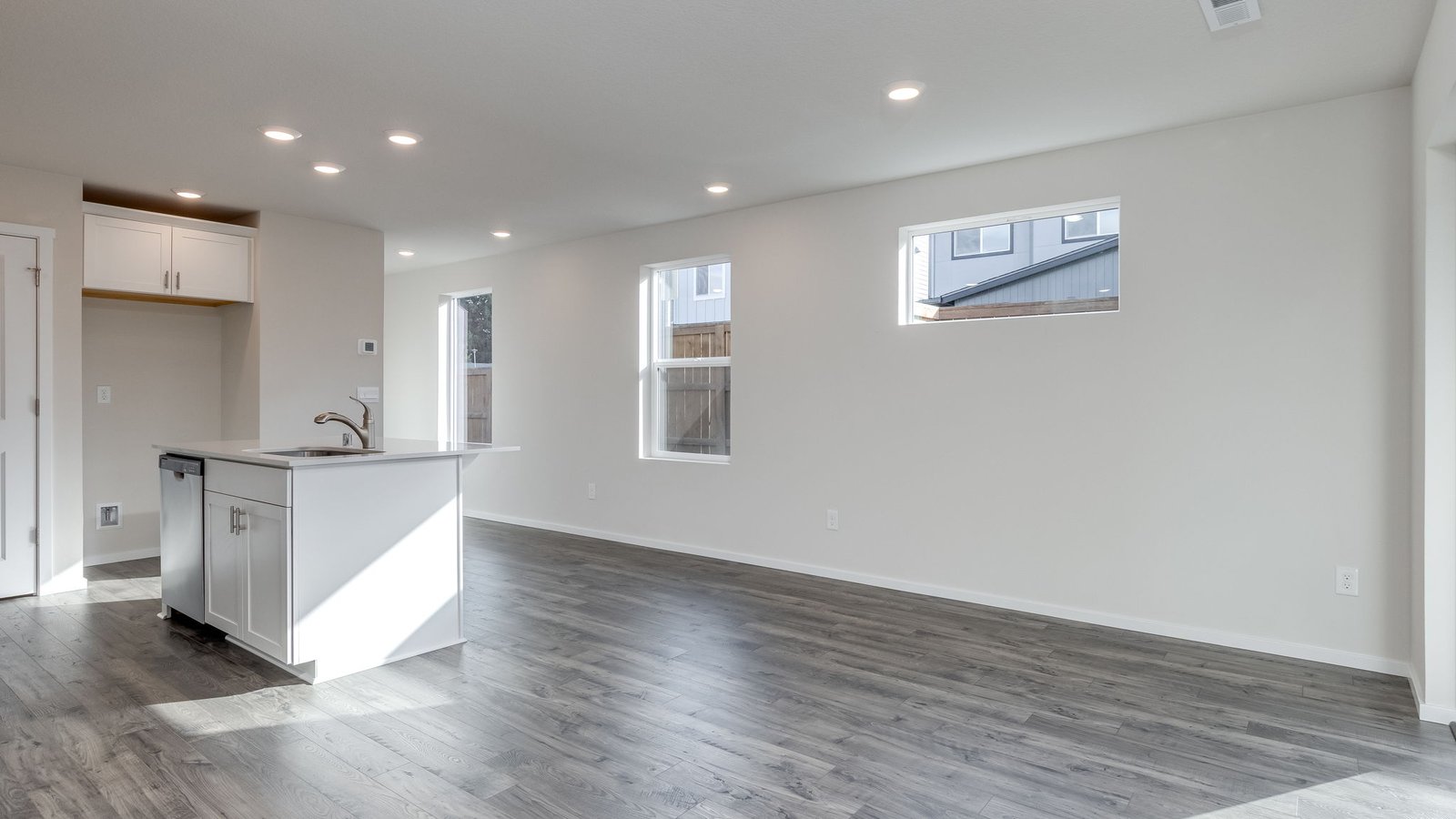 Great room with laminate flooring and an electric fireplace