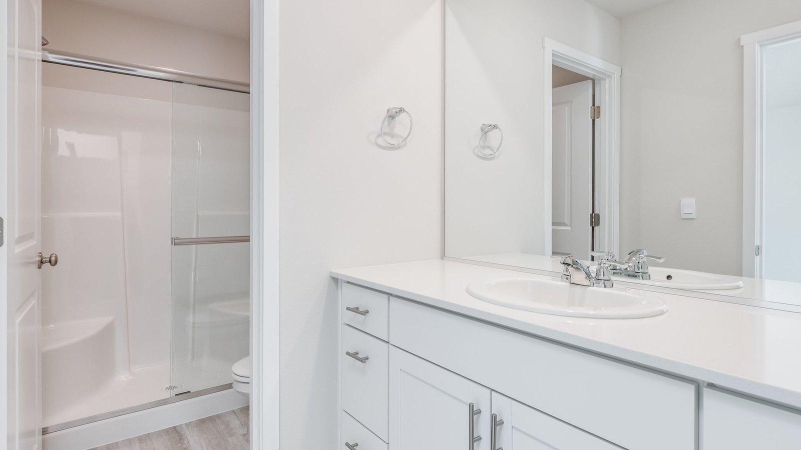 Primary bathroom with quartz counters and a walk-in shower