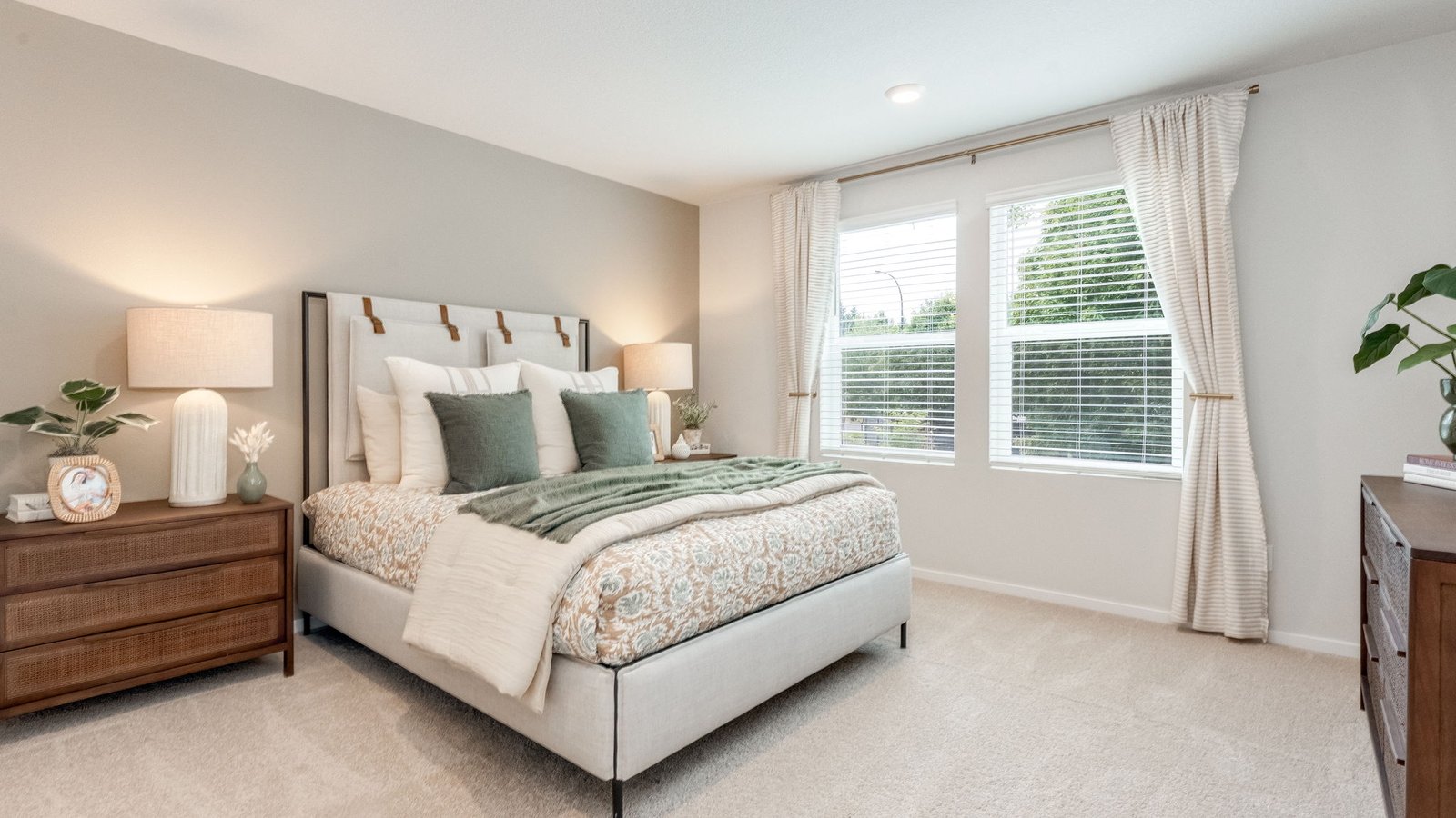 Primary bedroom with wall-to-wall carpet, a walk-in closet and an attached bathroom