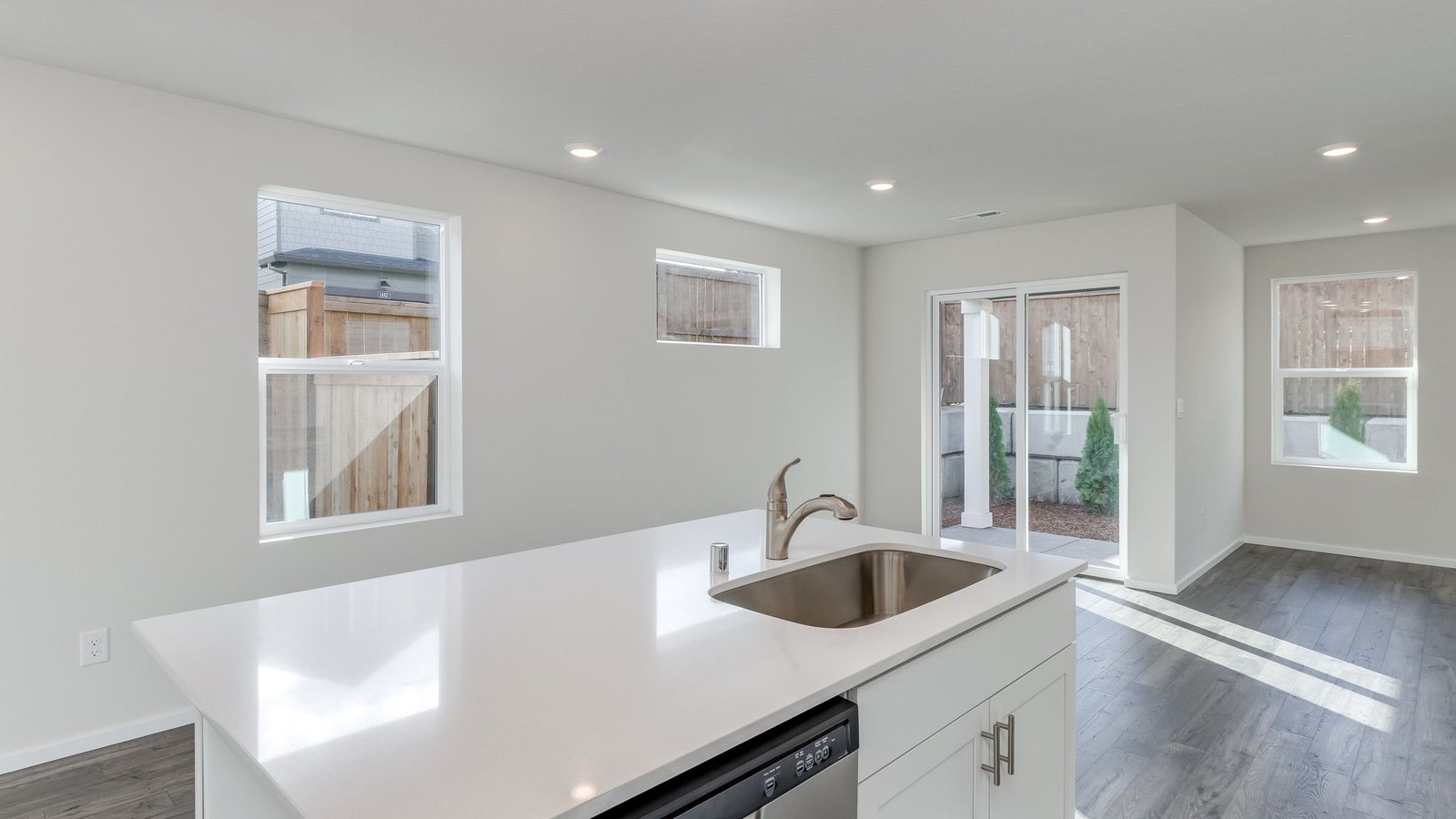 Kitchen with shaker cabinets, quartz counters, stainless steel appliances, pantry, and an island with a breakfast bar