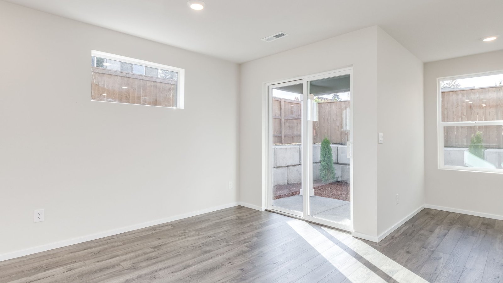 Dining area with a sliding glass door to a fenced backyard