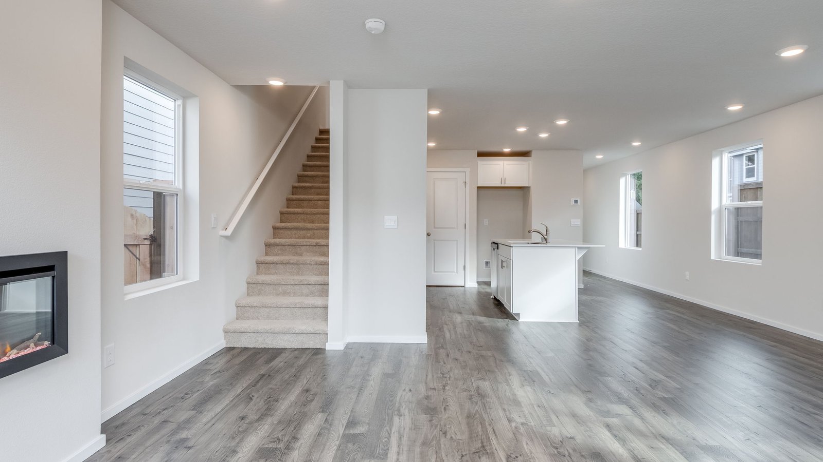 Great room with laminate flooring and an electric fireplace