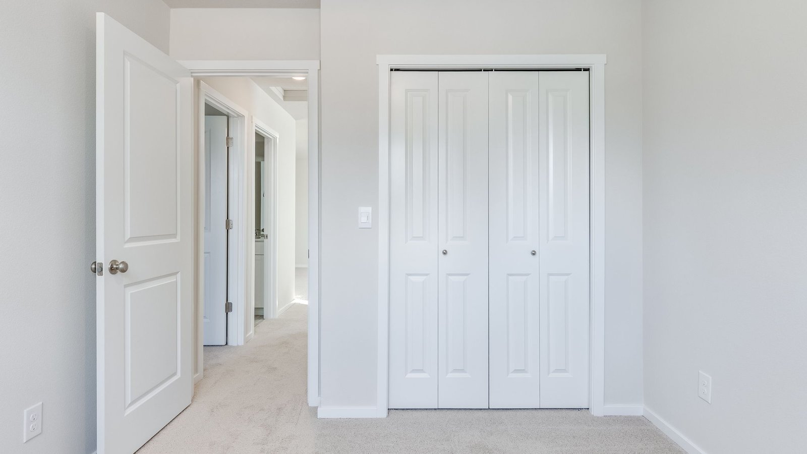 Bedroom with wall-to-wall carpet and a closet