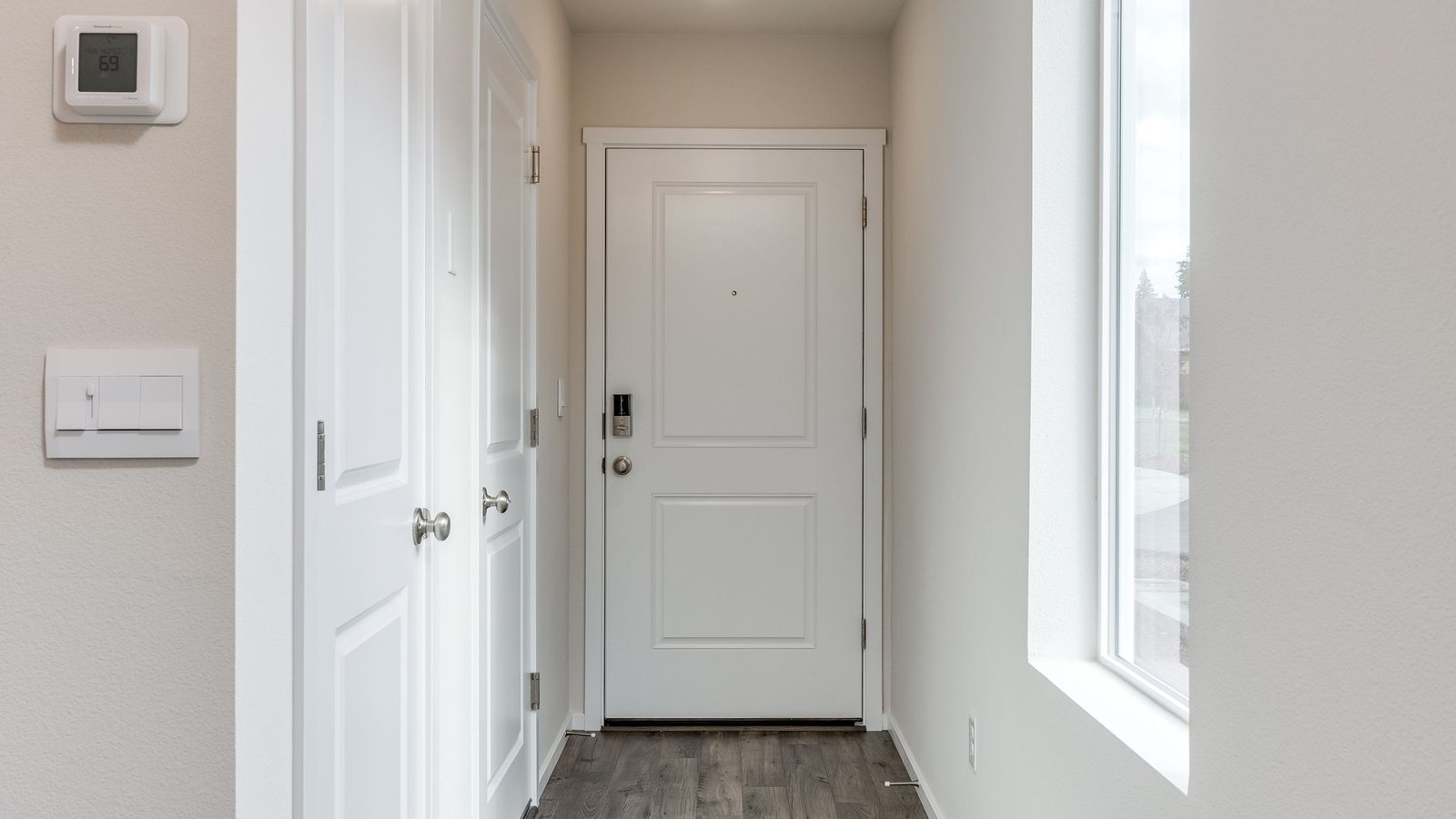 Entryway with a coat closet and laminate flooring