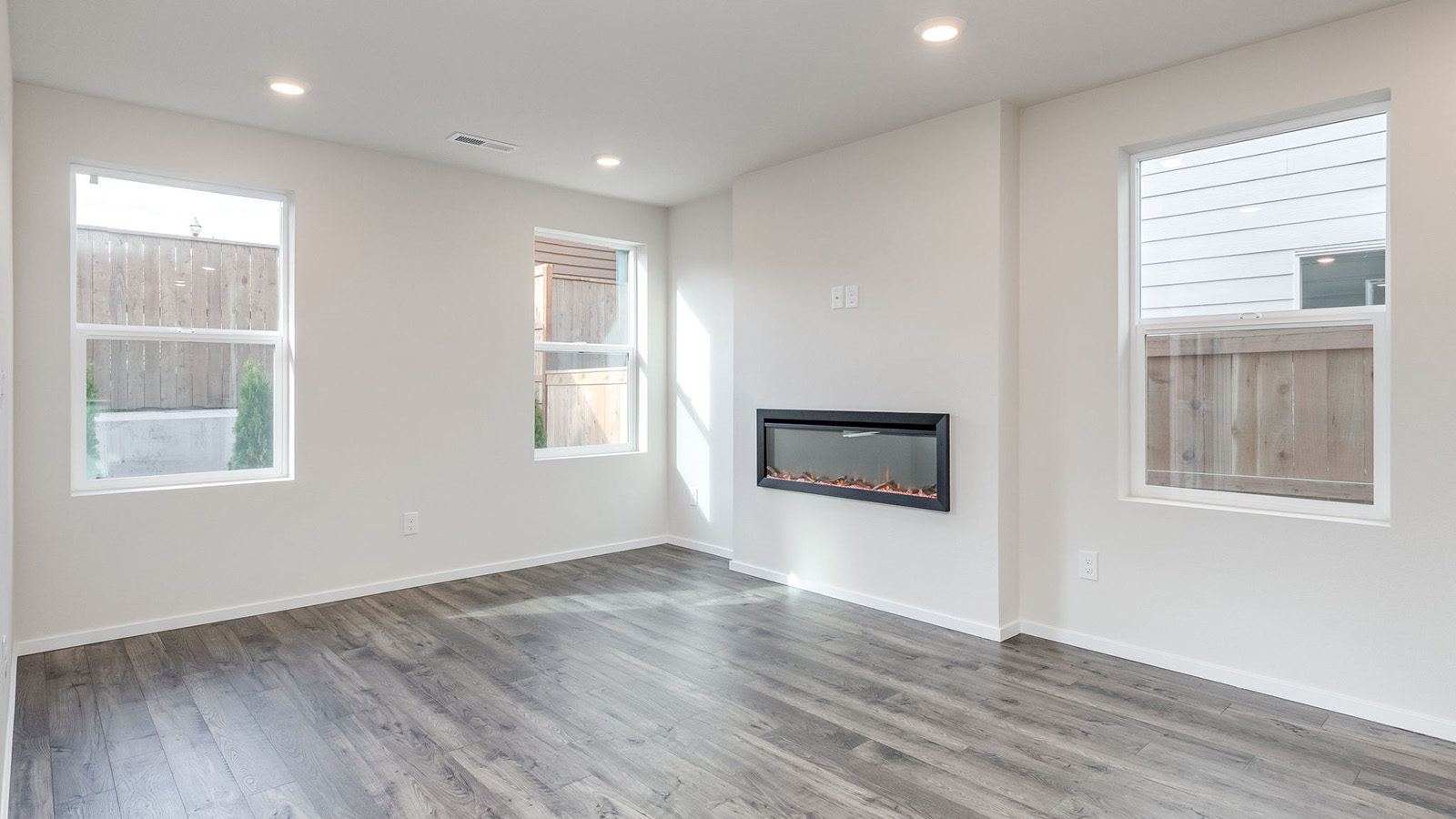 Great room with laminate flooring and an electric fireplace