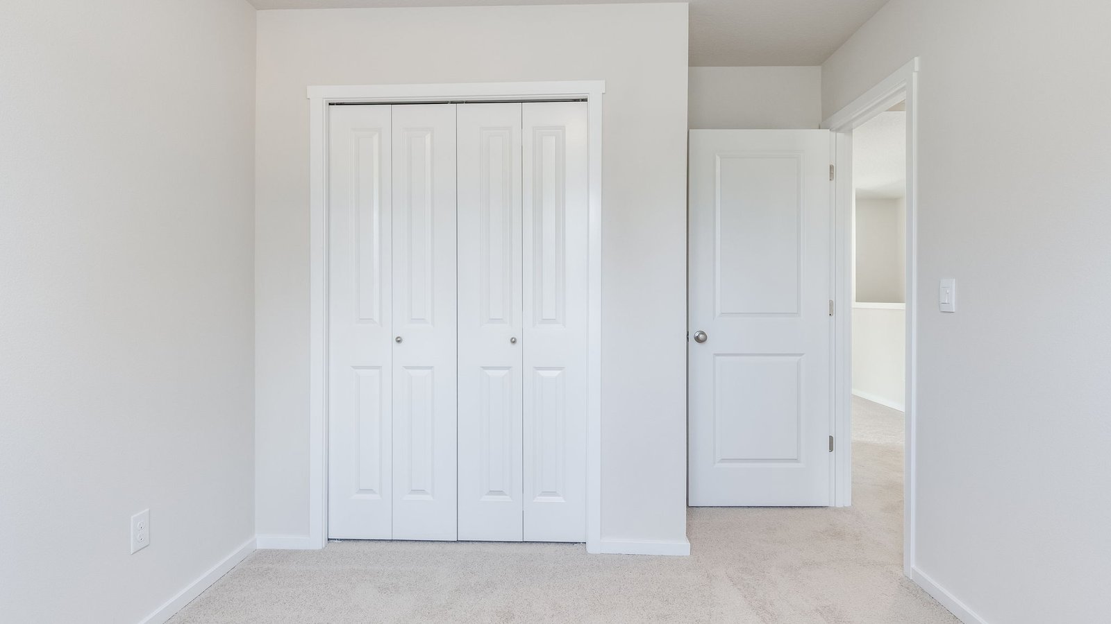 Bedroom with wall-to-wall carpet and a closet