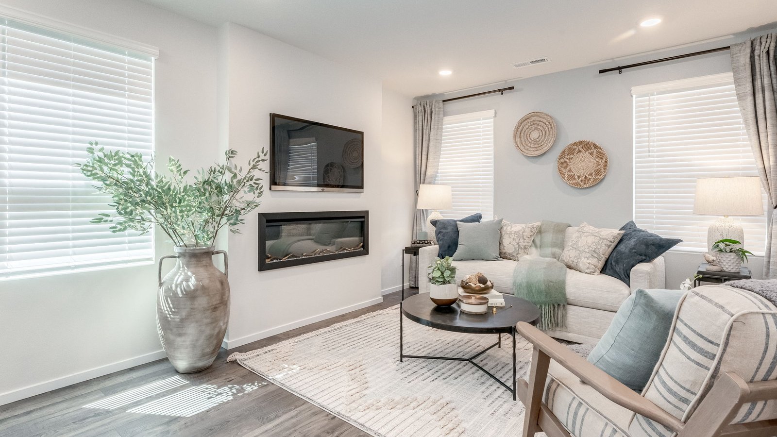 Great room with laminate flooring and an electric fireplace