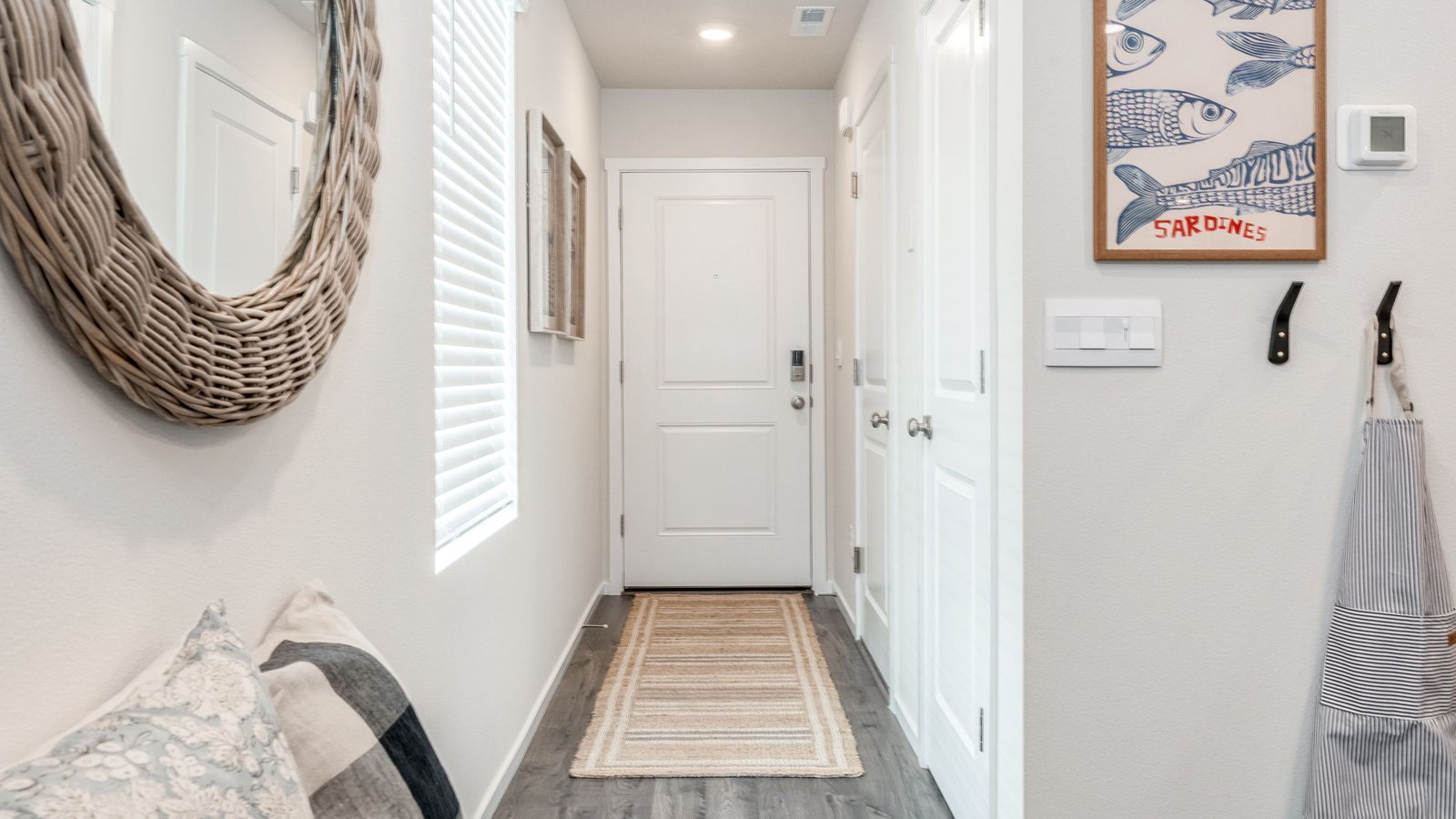 Entryway with a coat closet and laminate flooring