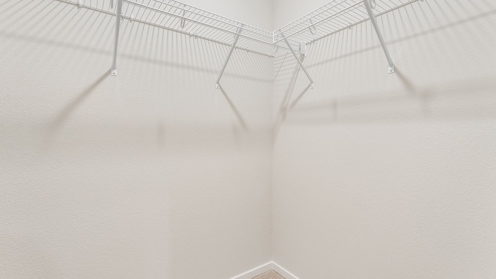 Primary bedroom walk-in closet with wire shelves