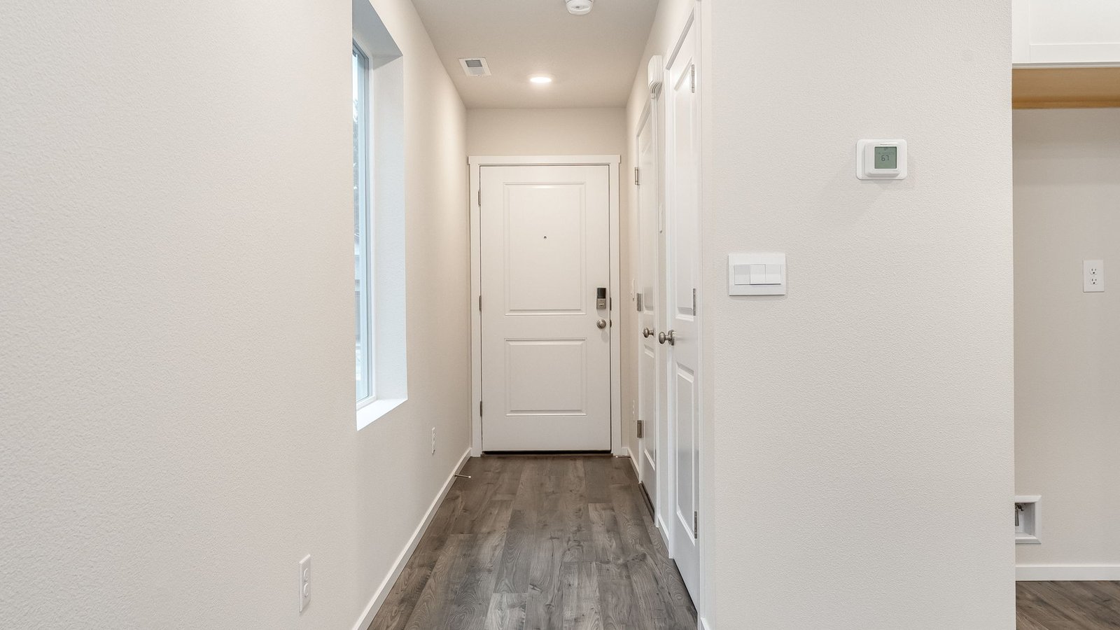 Entryway with a coat closet and laminate flooring