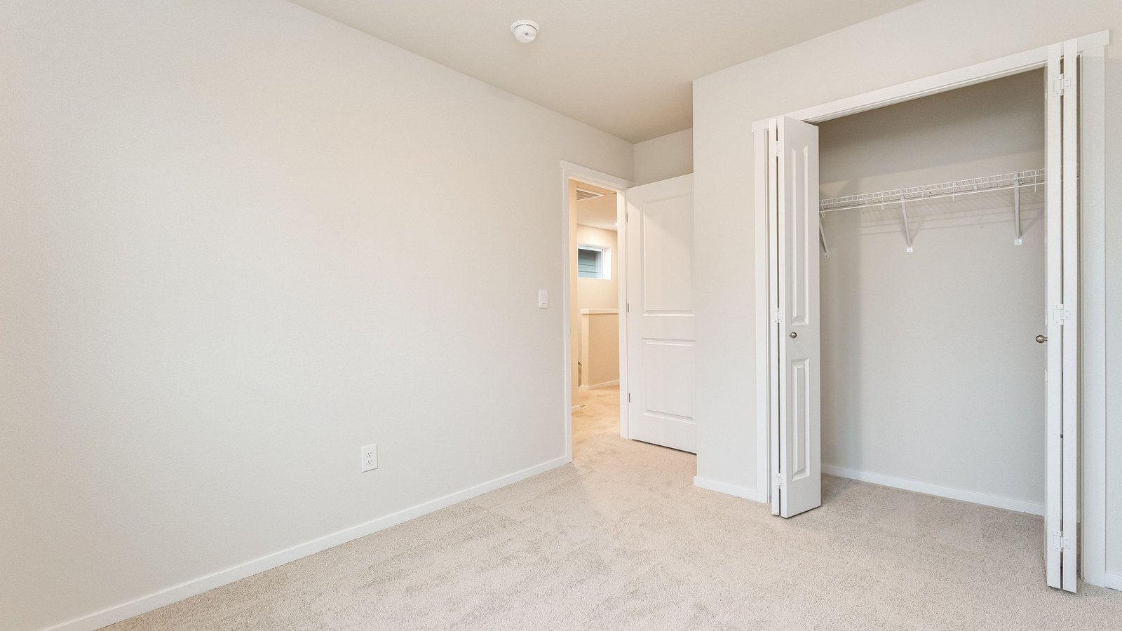 Bedroom with wall-to-wall carpet and a closet
