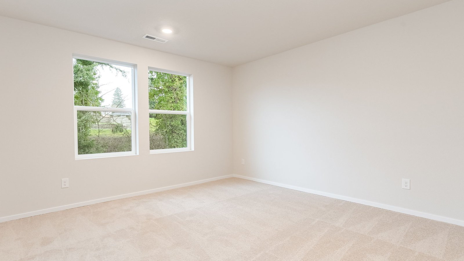 Primary bedroom with wall-to-wall carpet, a walk-in closet and an attached bathroom