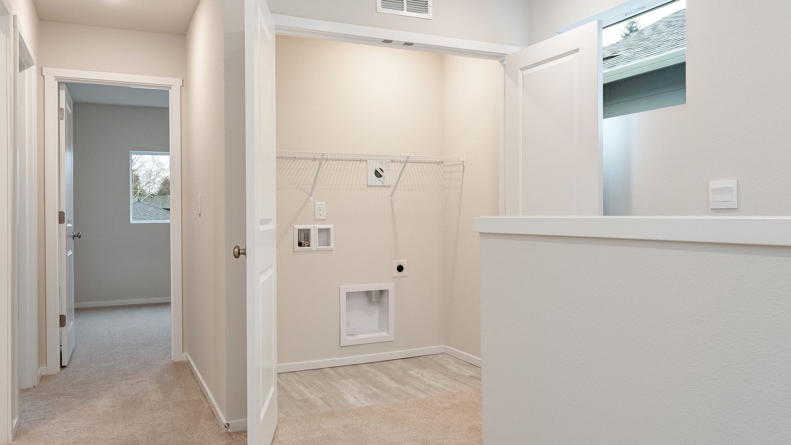 Laundry closet with wire shelves and washer and dryer hookups