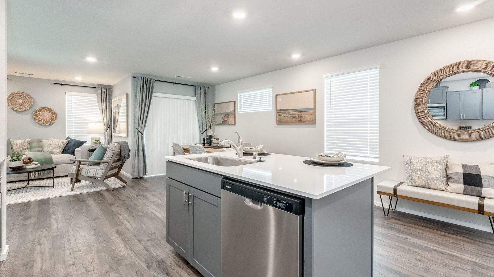 Kitchen with shaker cabinets, quartz counters, stainless steel appliances, pantry, and an island with a breakfast bar