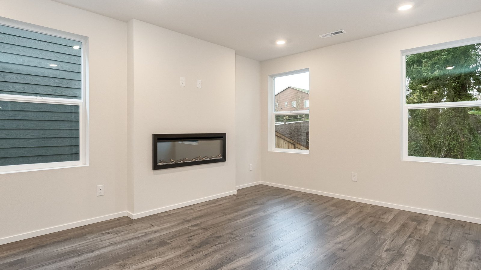 Great room with laminate flooring and an electric fireplace