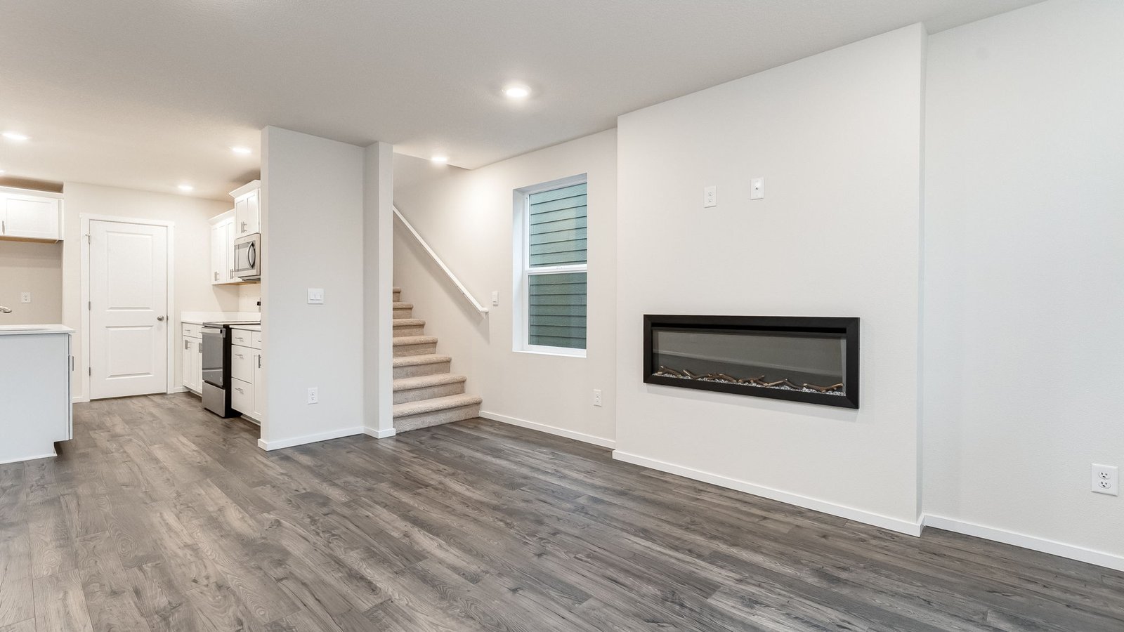 Great room with laminate flooring and an electric fireplace
