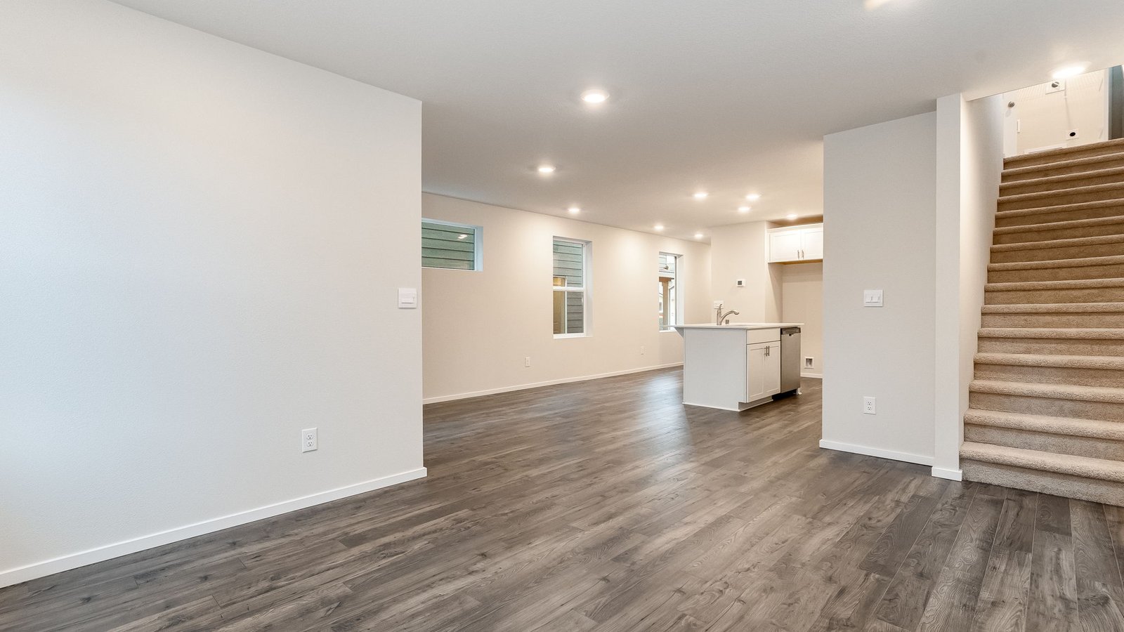 Great room with laminate flooring and an electric fireplace