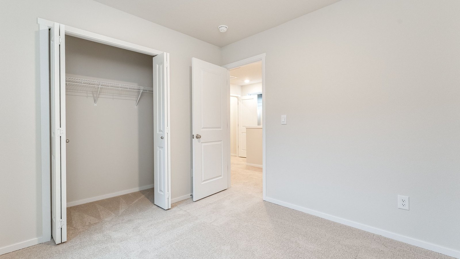 Bedroom with wall-to-wall carpet and a closet