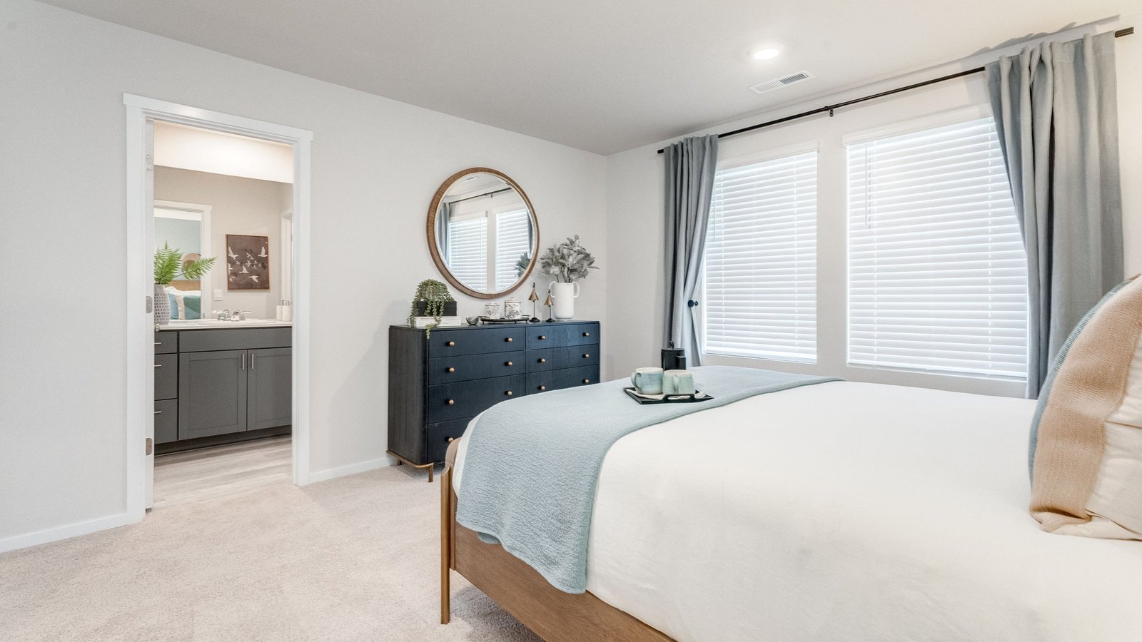 Primary bedroom with wall-to-wall carpet, a walk-in closet and an attached bathroom