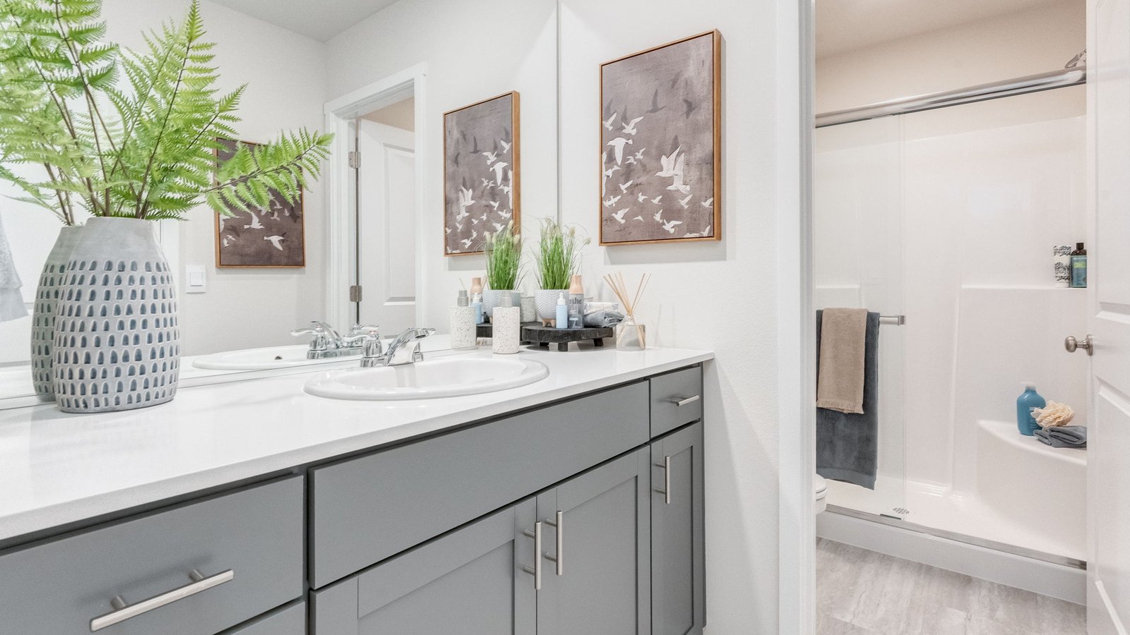 Primary bathroom with quartz counters and a walk-in shower