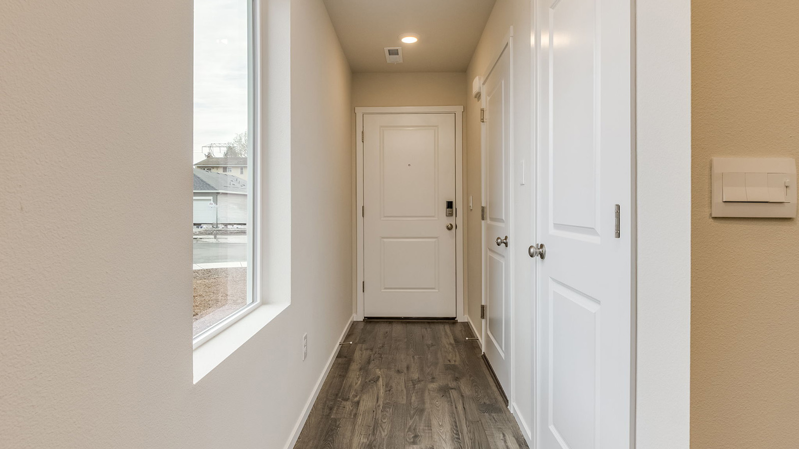 Entryway with a coat closet and laminate flooring
