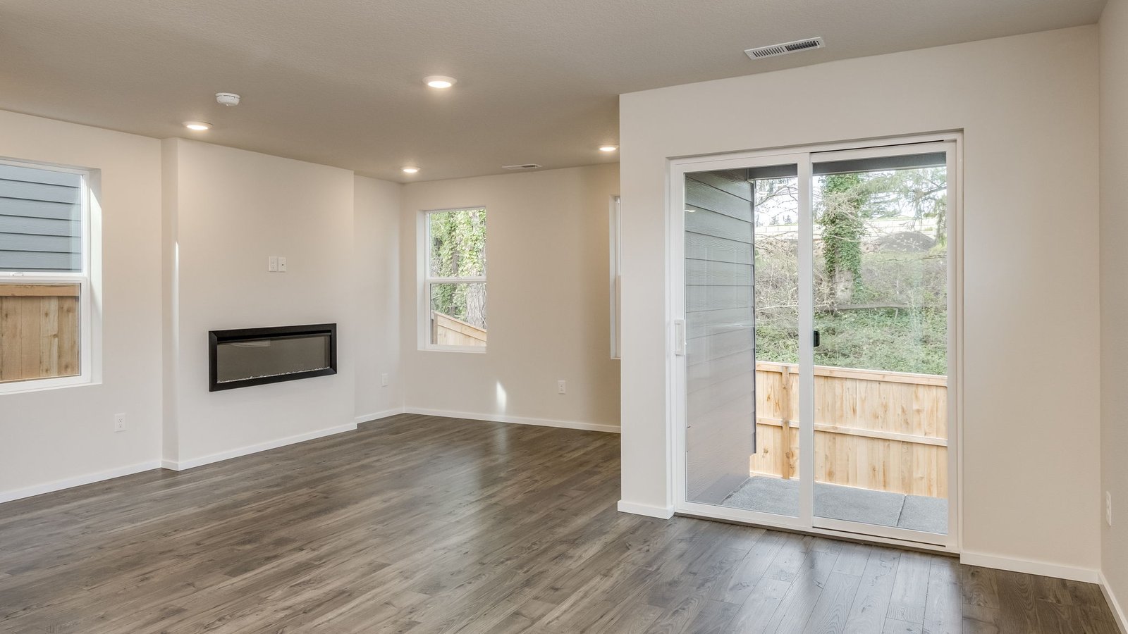 Dining area with a sliding glass door to a fenced backyard