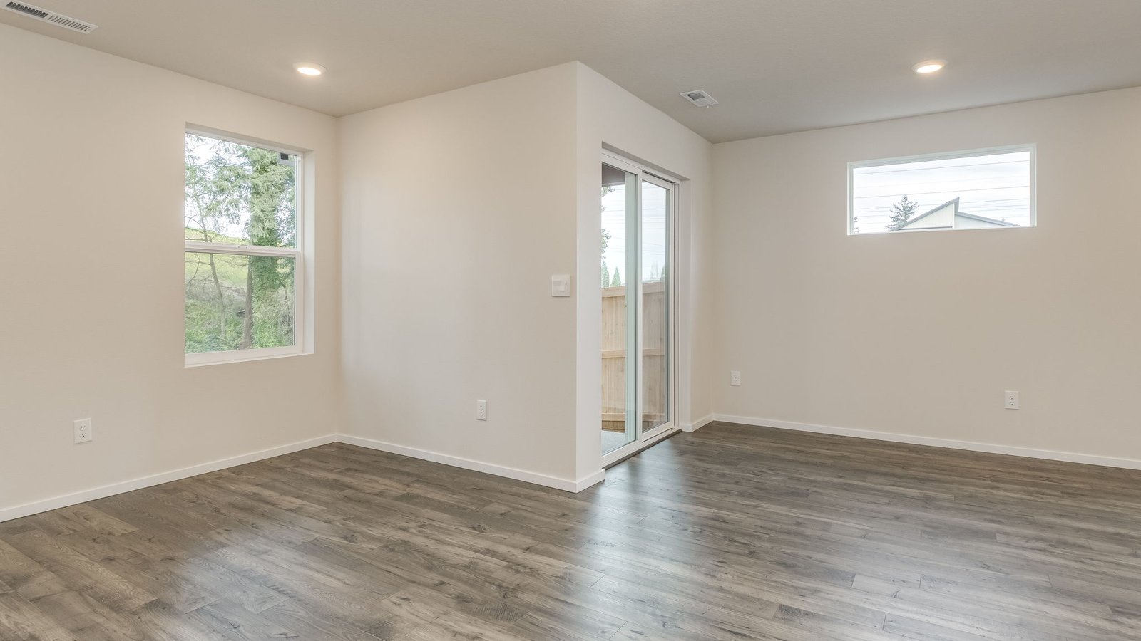 Dining area with a sliding glass door to a fenced backyard