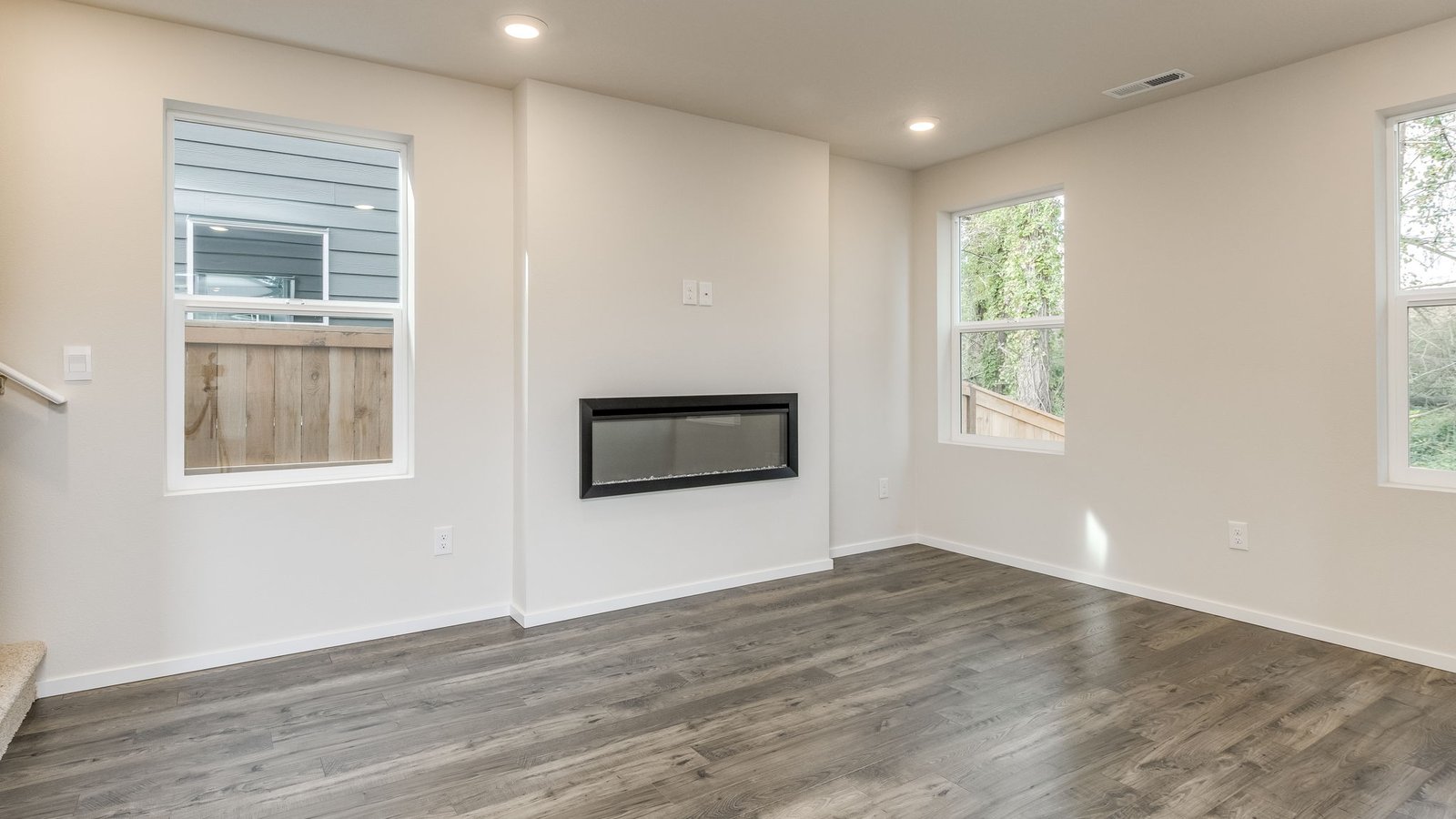 Great room with laminate flooring and an electric fireplace
