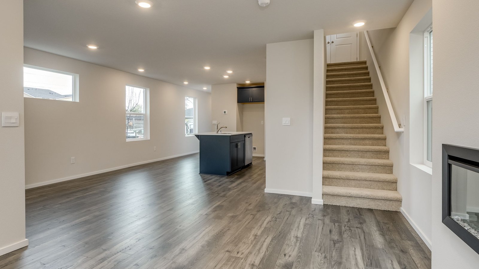 Great room with laminate flooring and an electric fireplace
