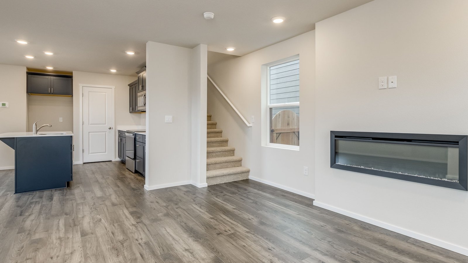 Great room with laminate flooring and an electric fireplace
