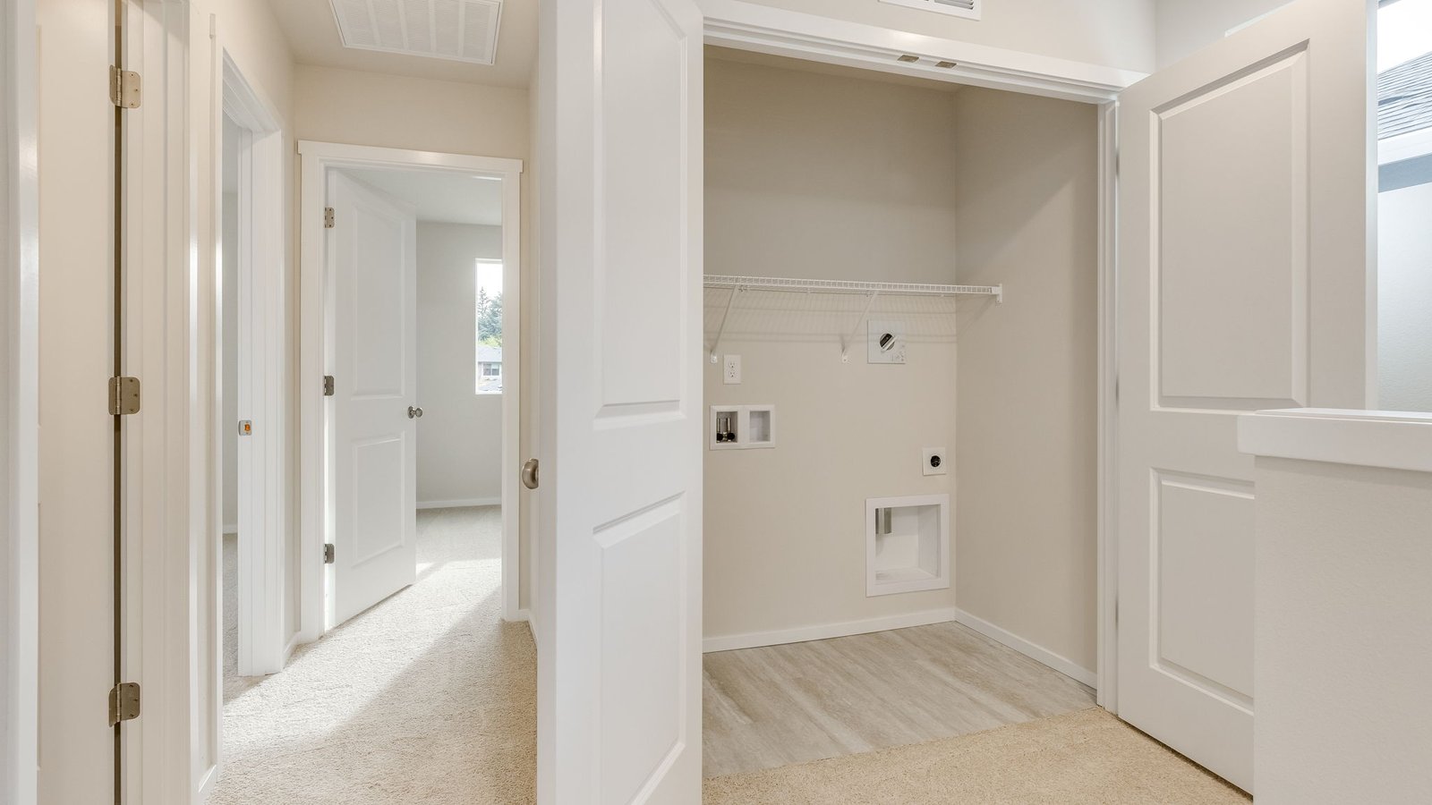 Laundry closet with wire shelves and washer and dryer hookups