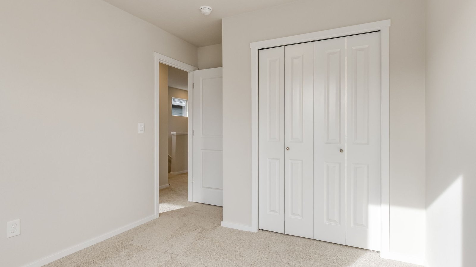 Bedroom with wall-to-wall carpet and a closet