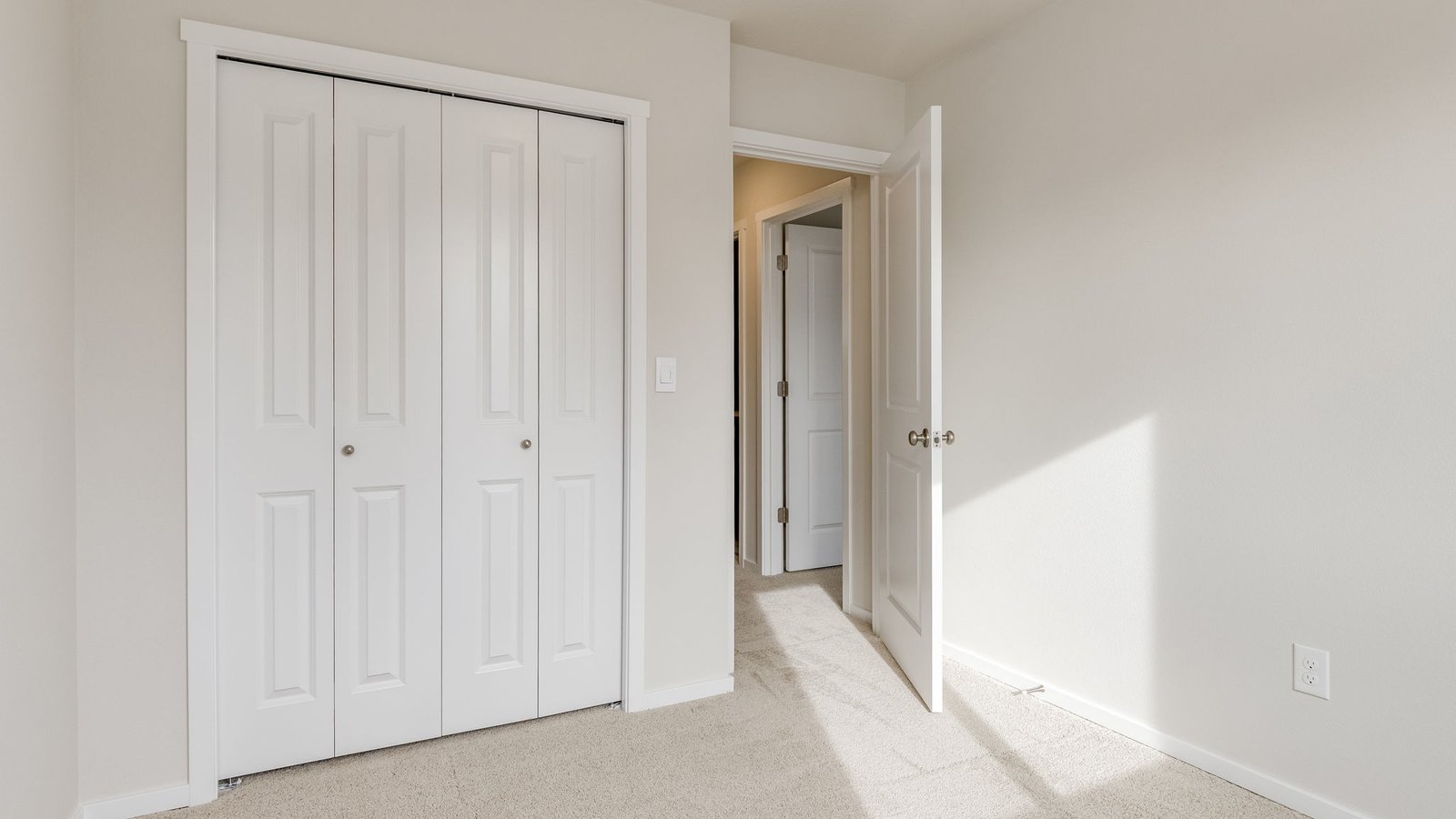 Bedroom with wall-to-wall carpet and a closet