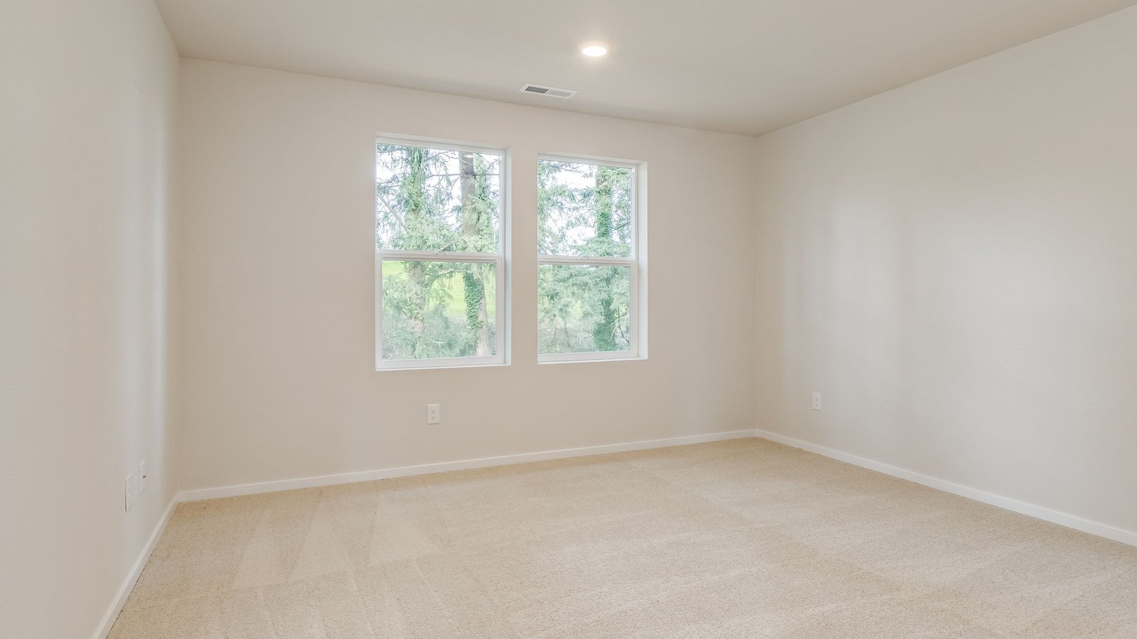 Primary bedroom with wall-to-wall carpet, a walk-in closet and an attached bathroom
