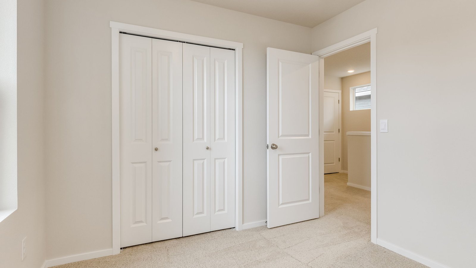 Bedroom with wall-to-wall carpet and a closet