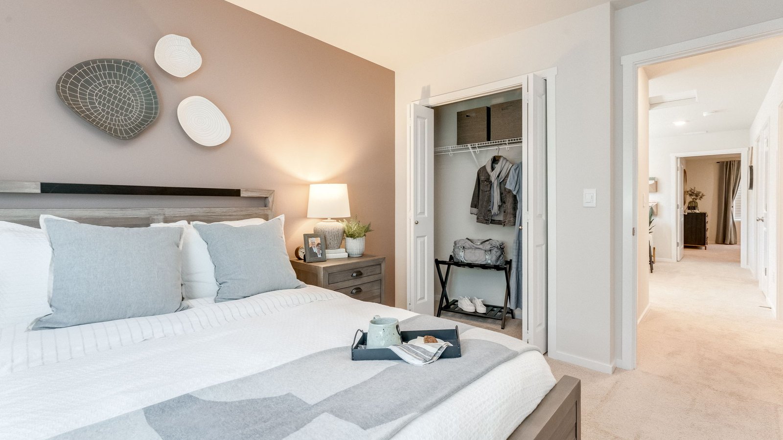 Bedroom with wall-to-wall carpet and a closet