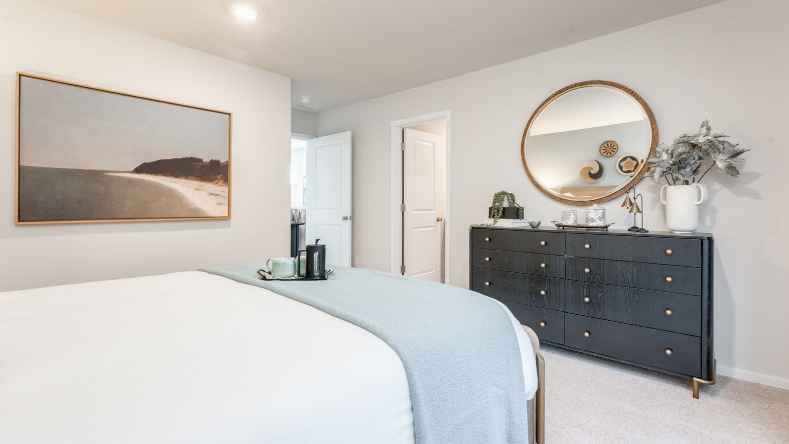 Primary bedroom with wall-to-wall carpet, a walk-in closet and an attached bathroom
