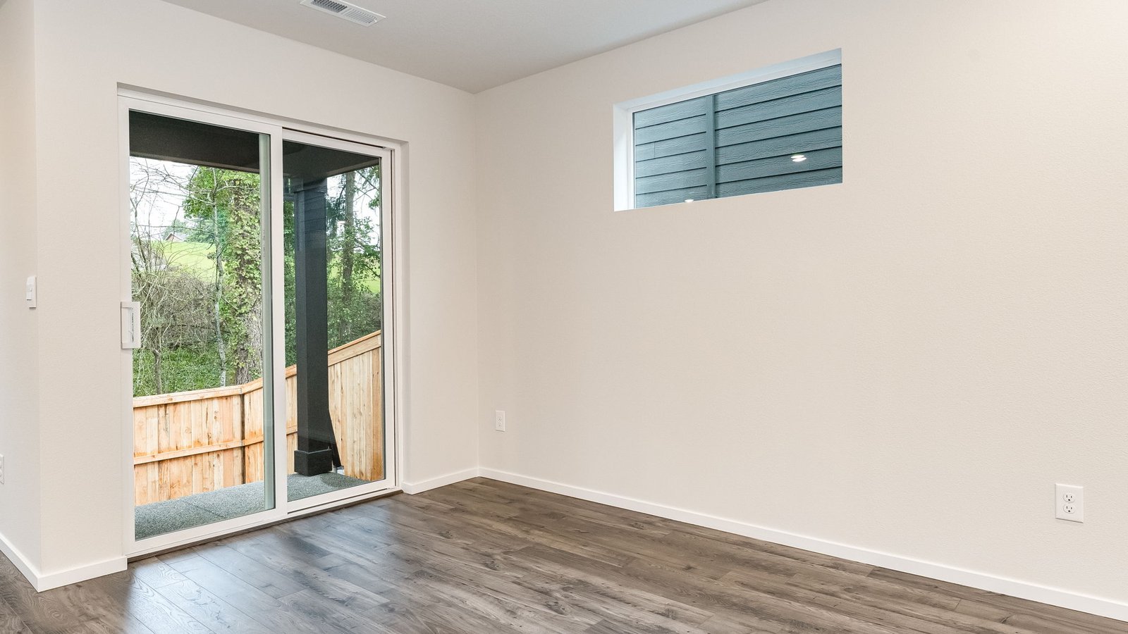 Dining area with a sliding glass door to a fenced backyard