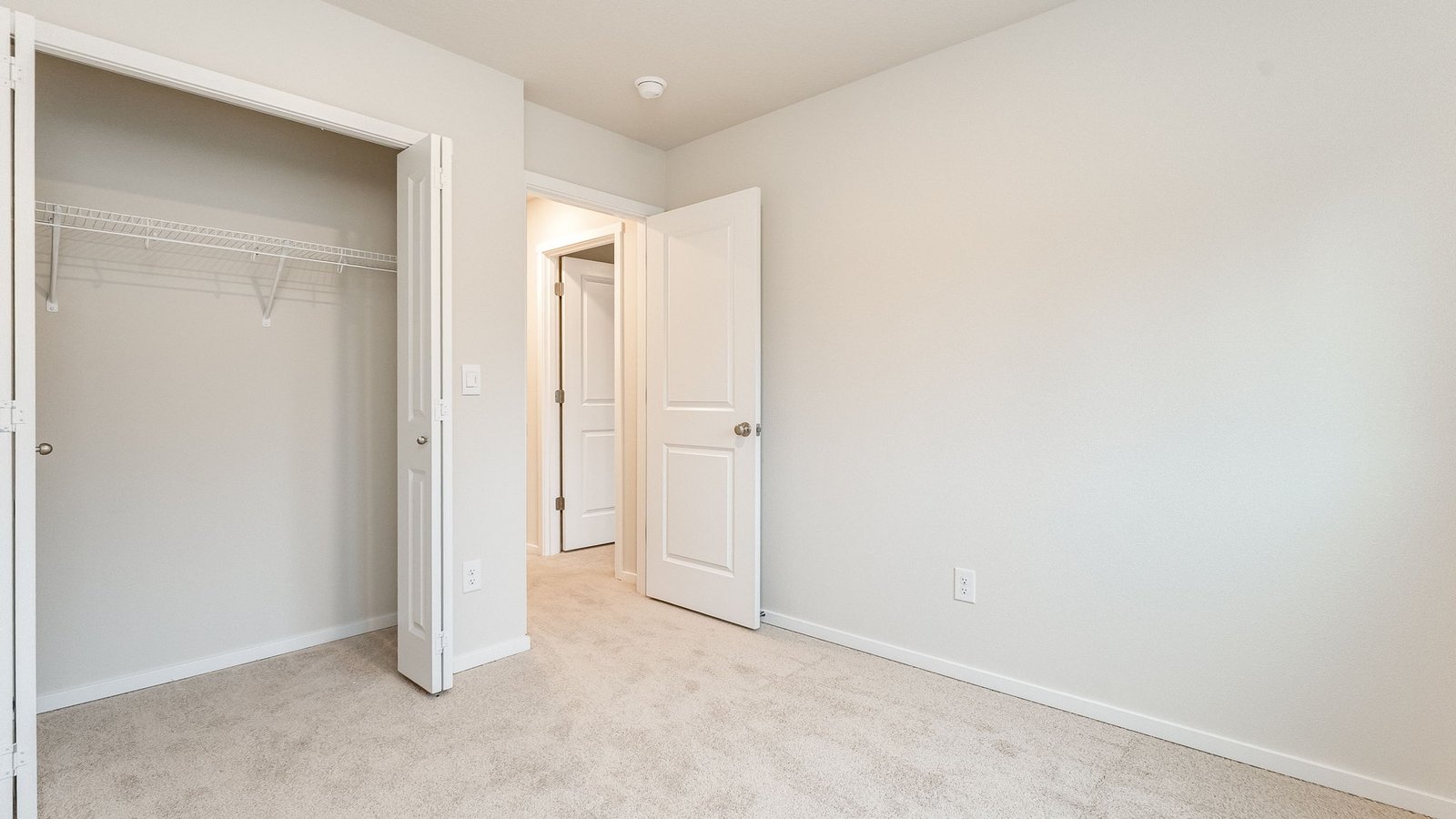 Bedroom with wall-to-wall carpet and a closet