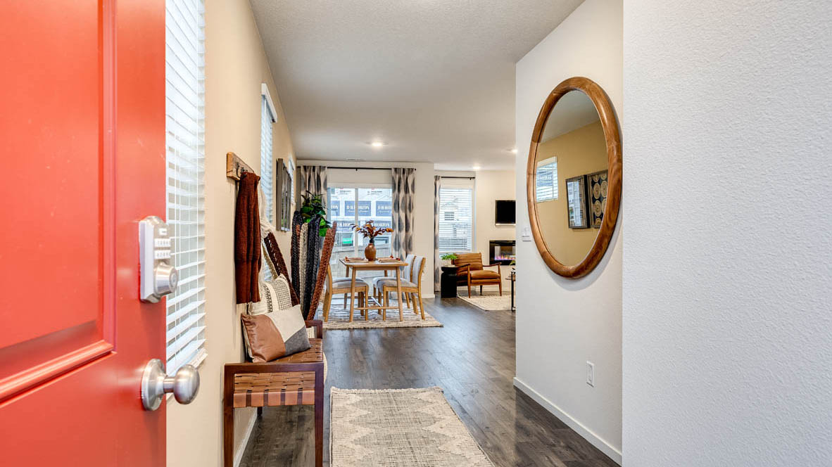 Entryway with a coat closet and laminate flooring