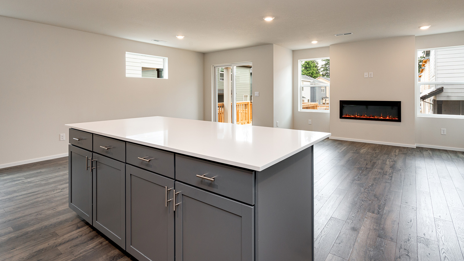 Kitchen with shaker cabinets, quartz counters, stainless steel appliances, pantry, and an island with a breakfast bar