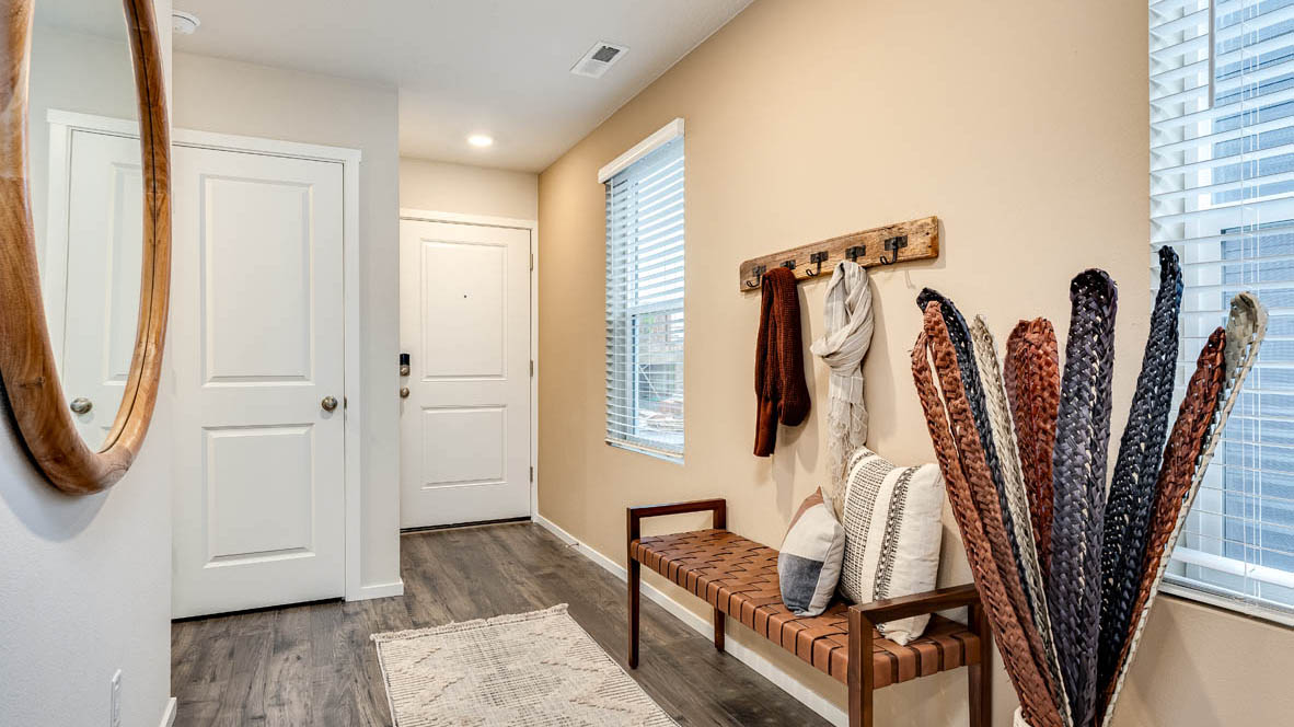 Entryway with a coat closet and laminate flooring