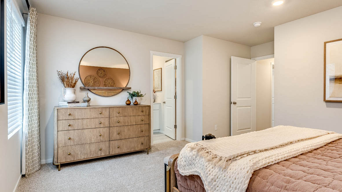 Primary bedroom with wall-to-wall carpet, a walk-in closet and an attached bathroom