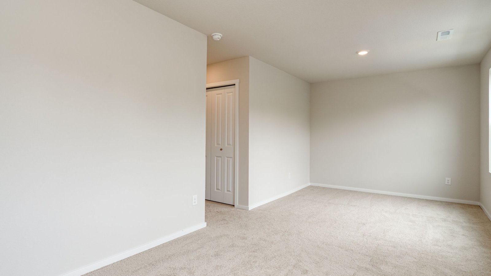 Bedroom with wall-to-wall carpet and a closet