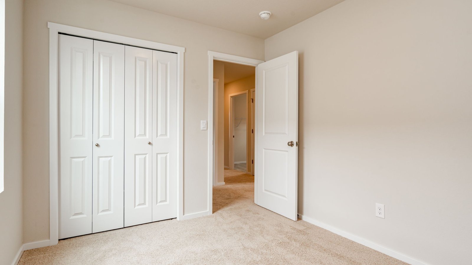 Bedroom with wall-to-wall carpet and a closet
